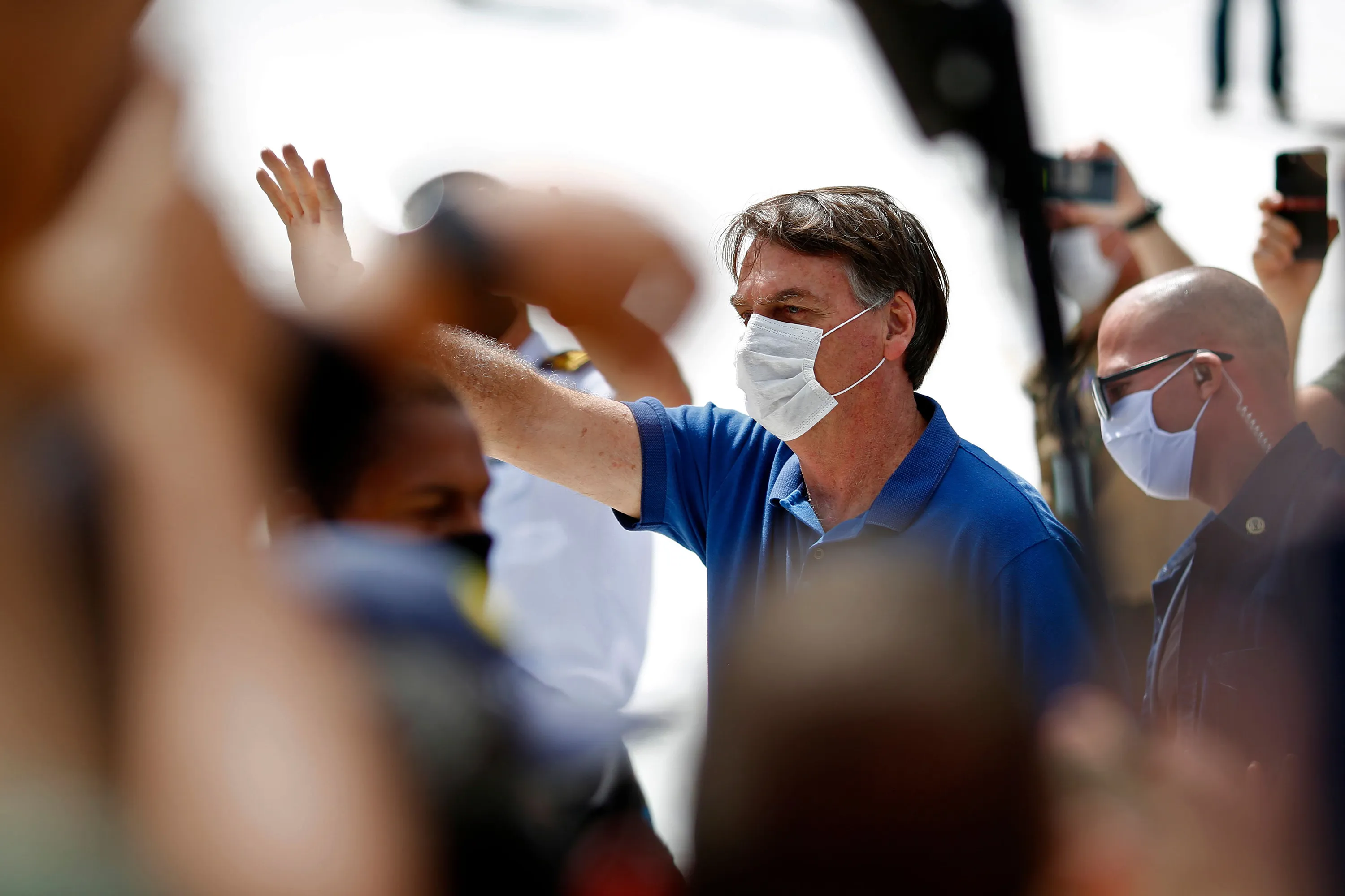 Jair Bolsonaro waves to supporters during a rally in Brasilia on May 17. 