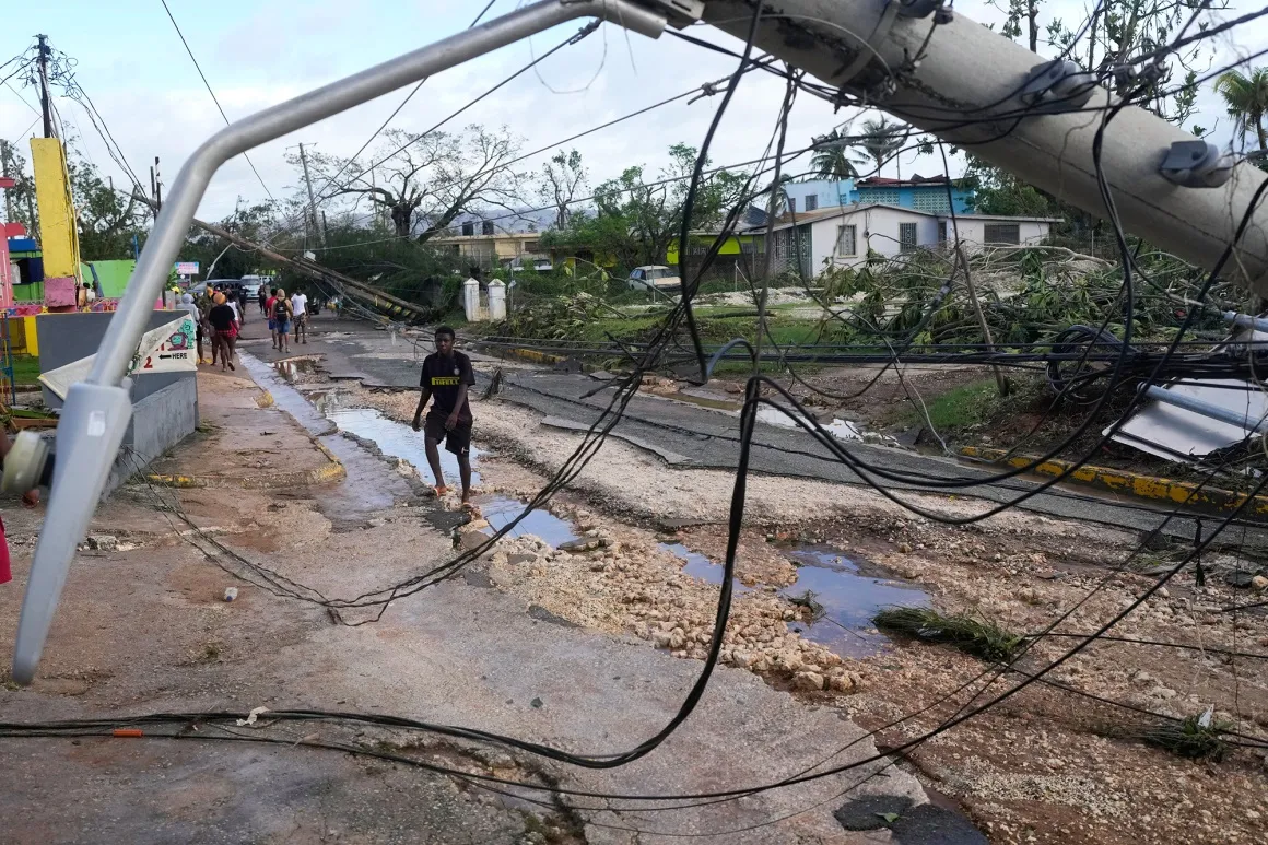 Residents walk through Santa Cruz, Jamaica after Hurricane Melissa passed on Oct. 29.