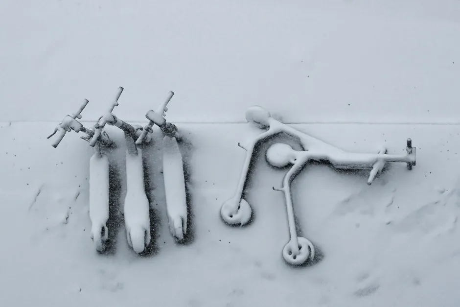 A flock of e-scooters enjoy their first snowfall in Kansas City in November.