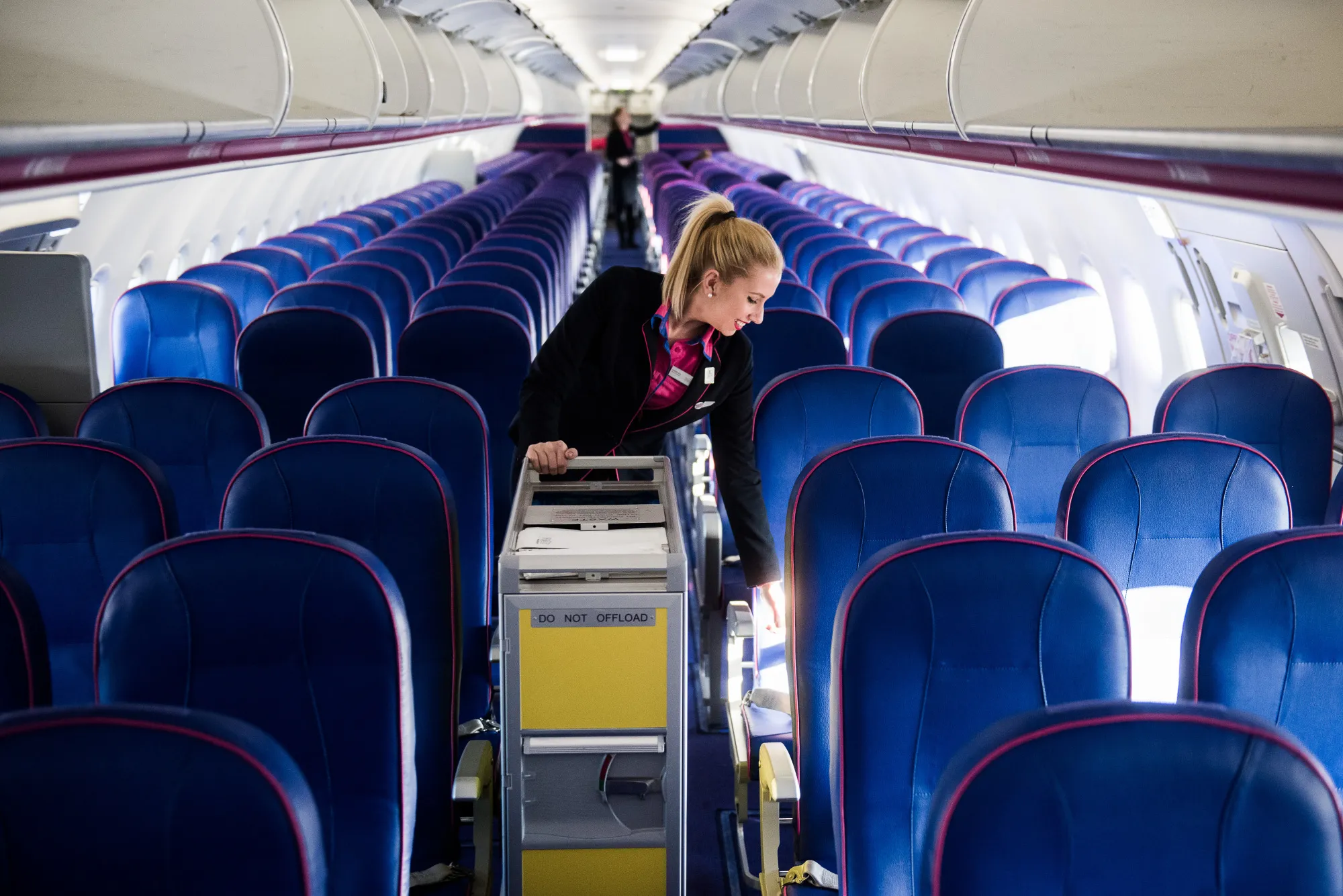 A flight attendant cleans the cabin after landing on-board a passenger aircraft operated by Wizz Air Holdings Plc, at Liszt Ferenc airport in Budapest.