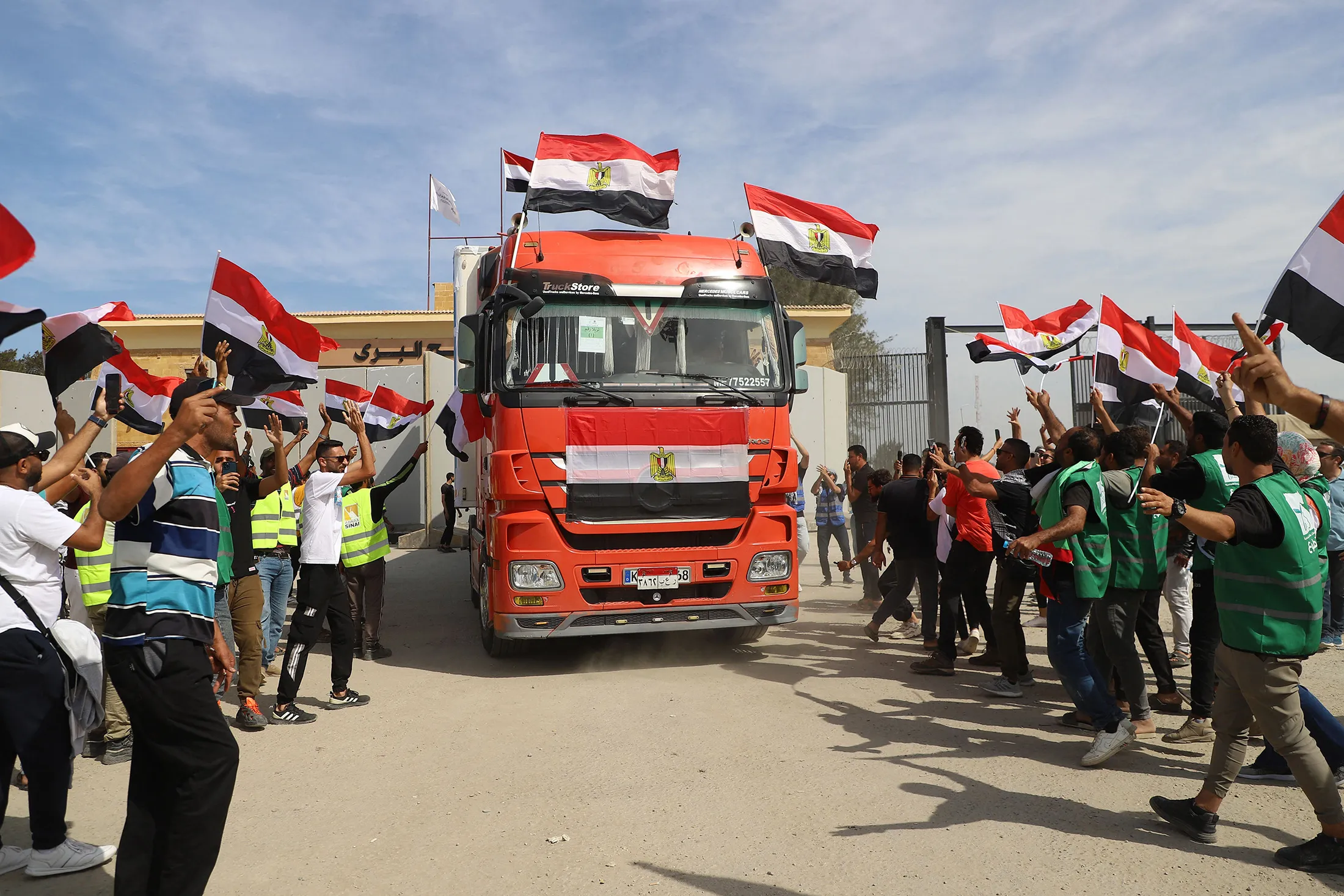 Egyptian aid workers celebrate as an aid truck crosses back into Egypt through the Rafah border crossing with the Gaza Strip on Oct.&nbsp;21.