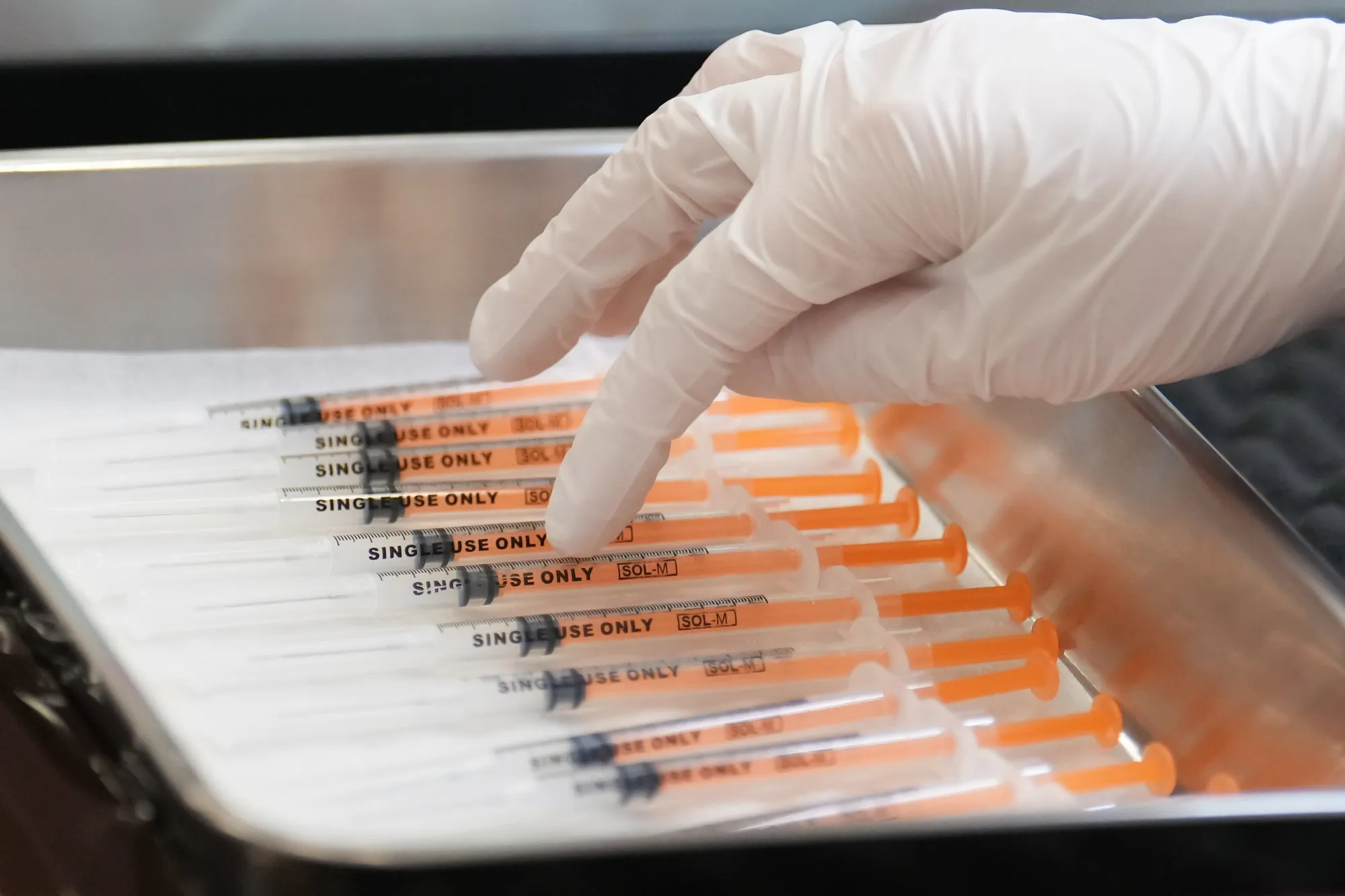 A healthcare worker prepares the Moderna Inc. Covid-19 vaccine shots.