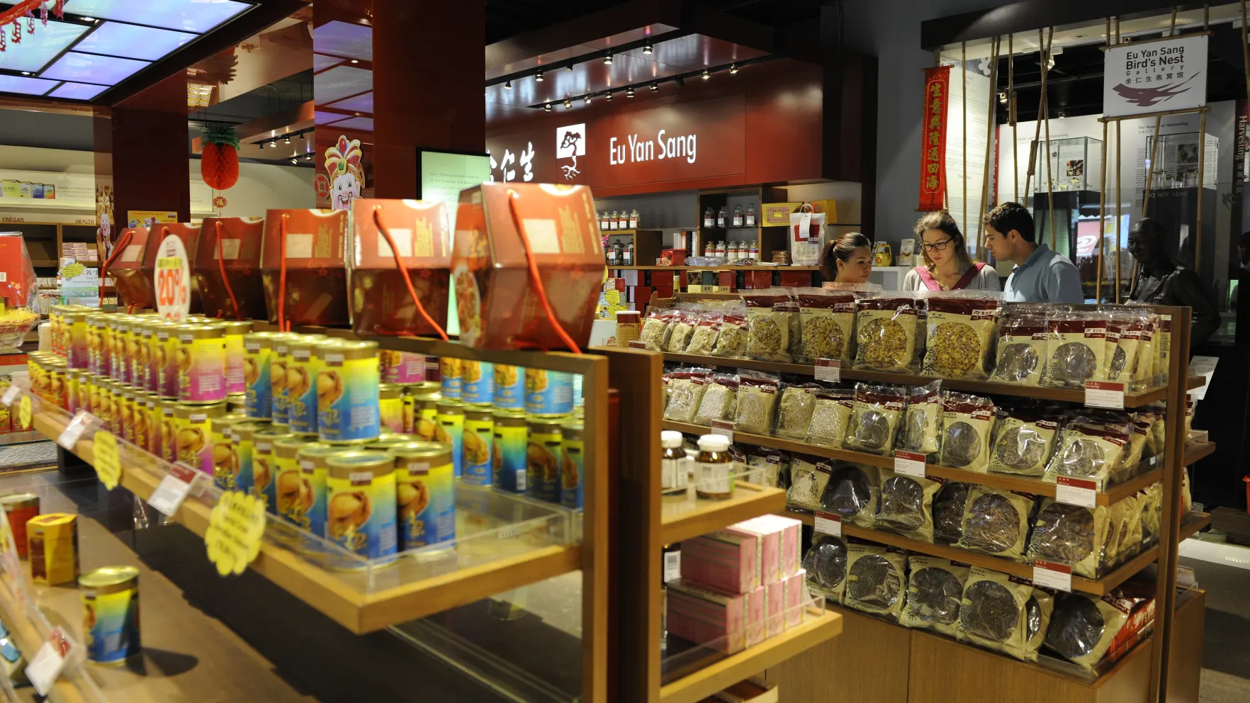 Customers browse traditional Chinese herbal products inside a Eu Yan Sang store in Singapore.