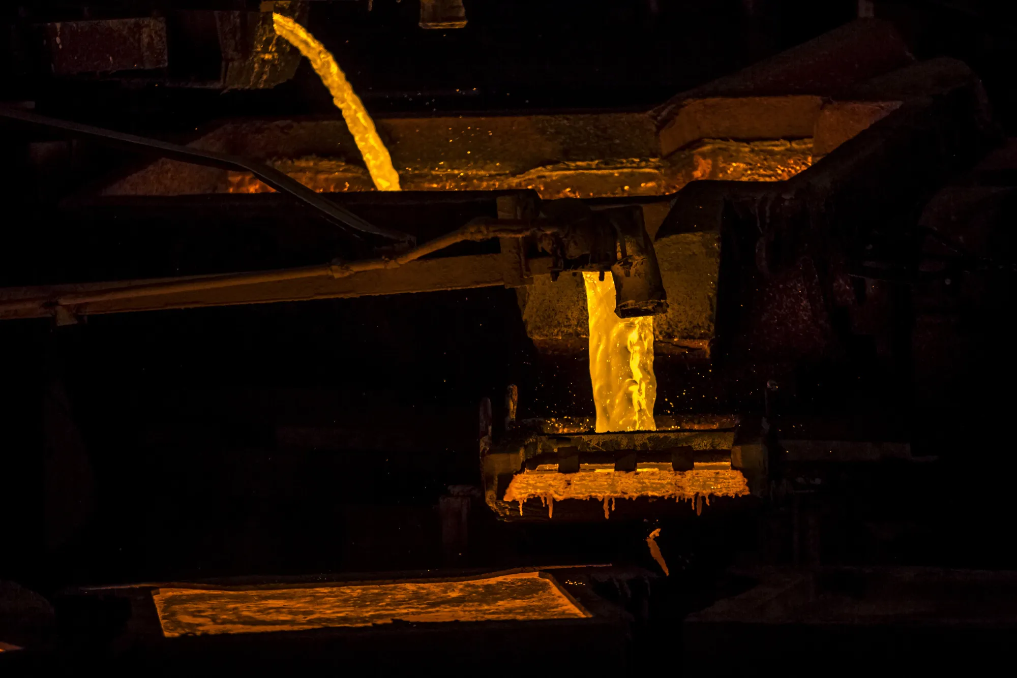Molten copper pours into ceramic molds to form plates at a&nbsp;smelter facility in Ilo, Peru.