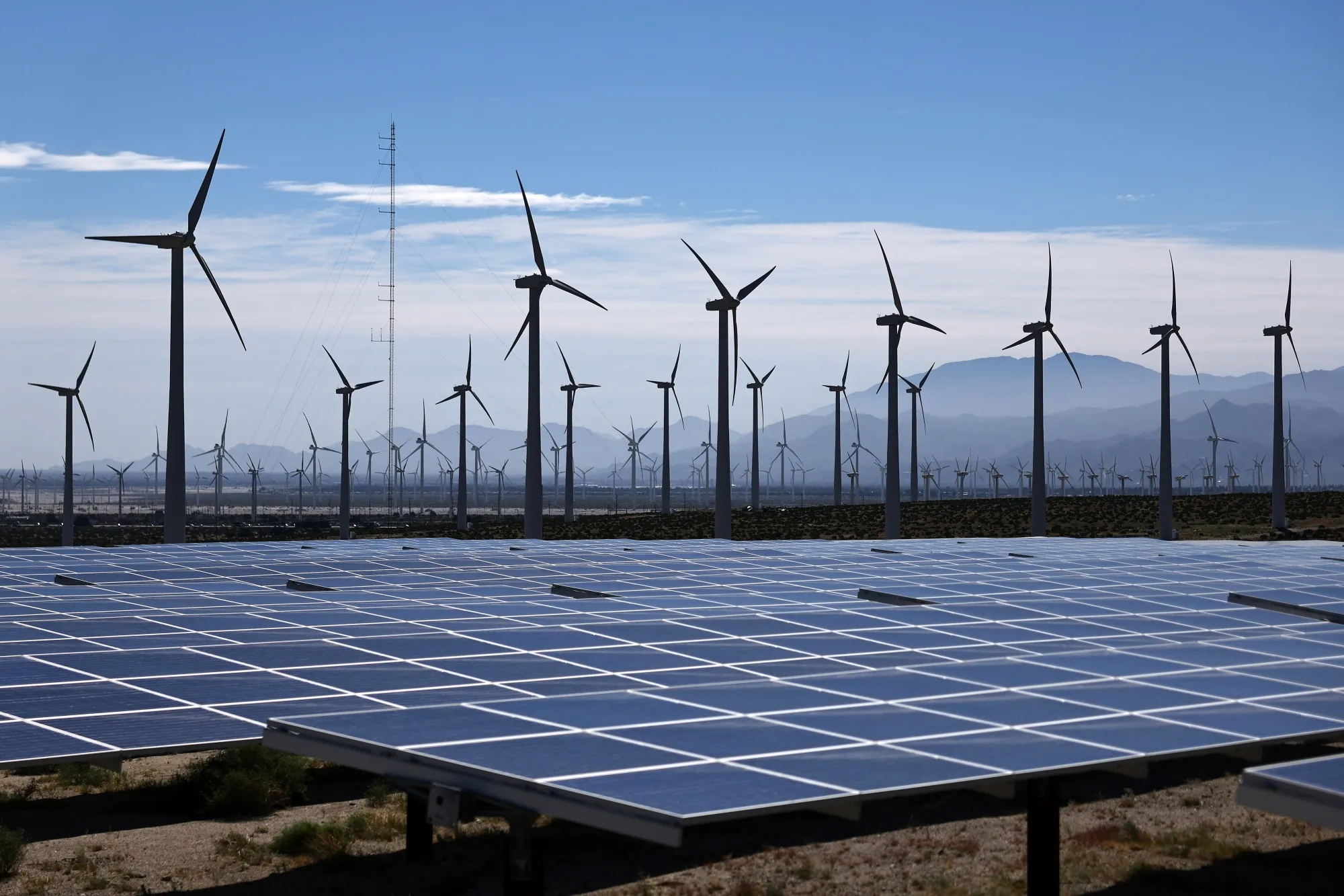 Wind turbines operate at a wind farm near solar panels near Palm Springs, California.