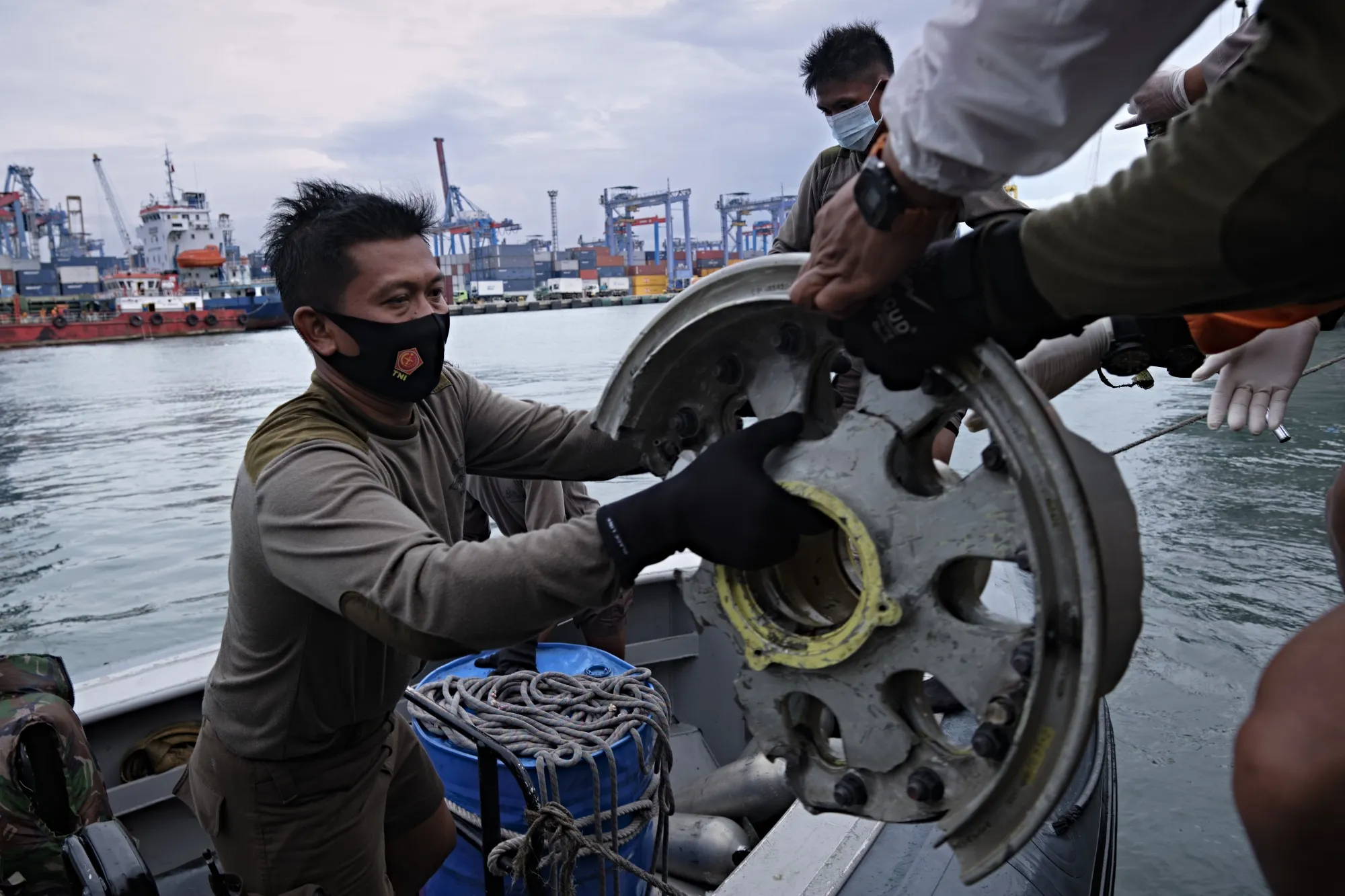 Marines offload debris recovered from Sriwijaya Air flight SJ182 crash site, in Jakarta on Jan. 10.
