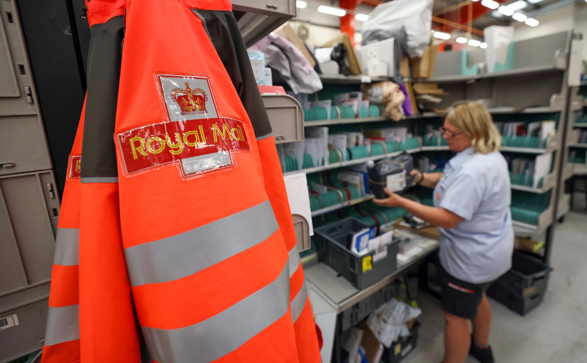 An employee sorts through post at a sorting office in Chelmsford, UK.