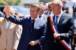 Emmanuel Macron and Touquet’s mayor Daniel Fasquelle leave after voting in French parliamentary elections at a polling station in Le Touquet on June 12.