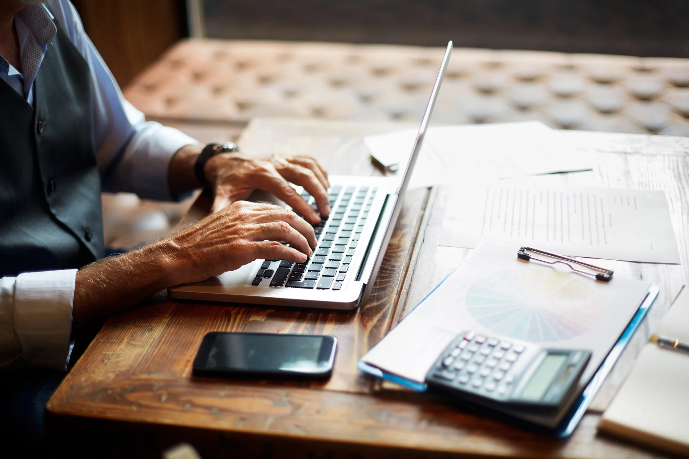 Senior businessman typing on a laptop  RF