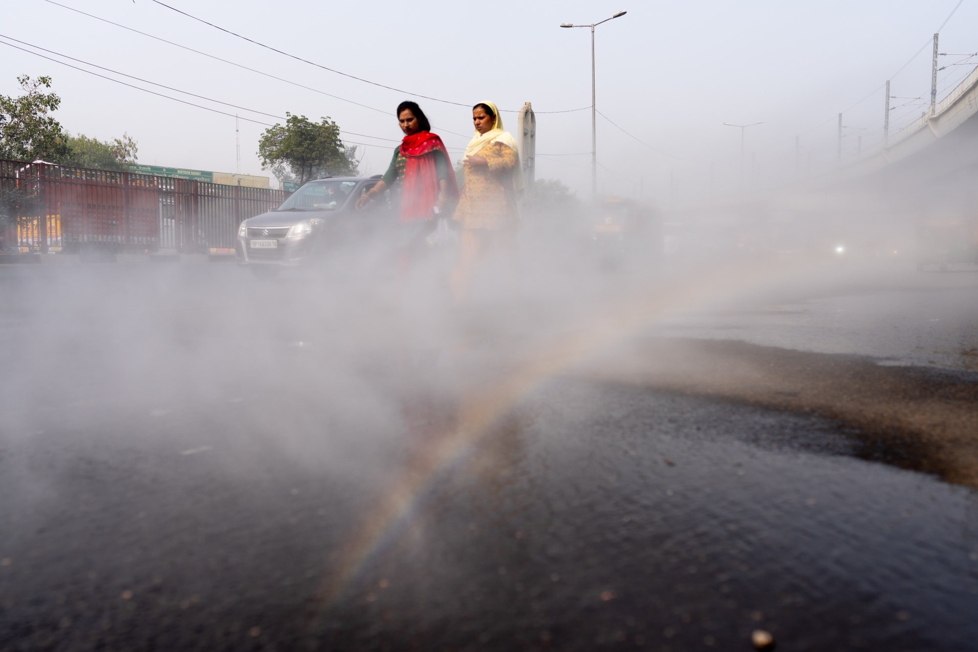 A vehicle sprays water onto the road for dust suppression during severe air pollution in New Delhi, India, on Thursday, Nov. 14, 2024. Nearly half the families in and around New Delhi have sought medical help for respiratory ailments connected to severe pollution engulfing India's capital, according to a new survey. Photographer: Anindito Mukherjee/Bloomberg