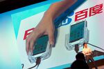 Smartphones are used to demonstrate Baidu’s new Internet browser at the company’s annual forum in Beijing