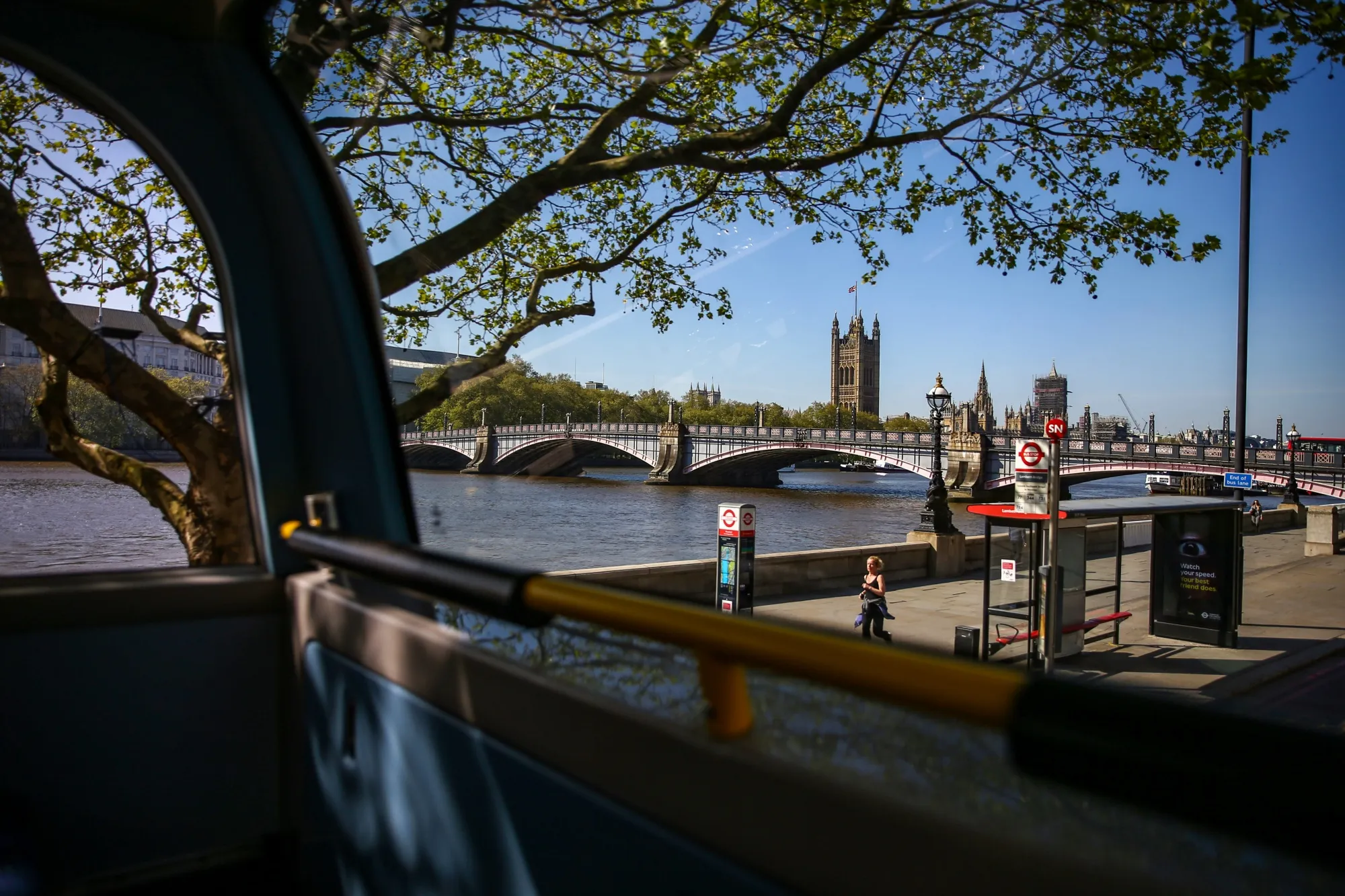 The Houses of Parliament stand in this view from inside a bus in London.