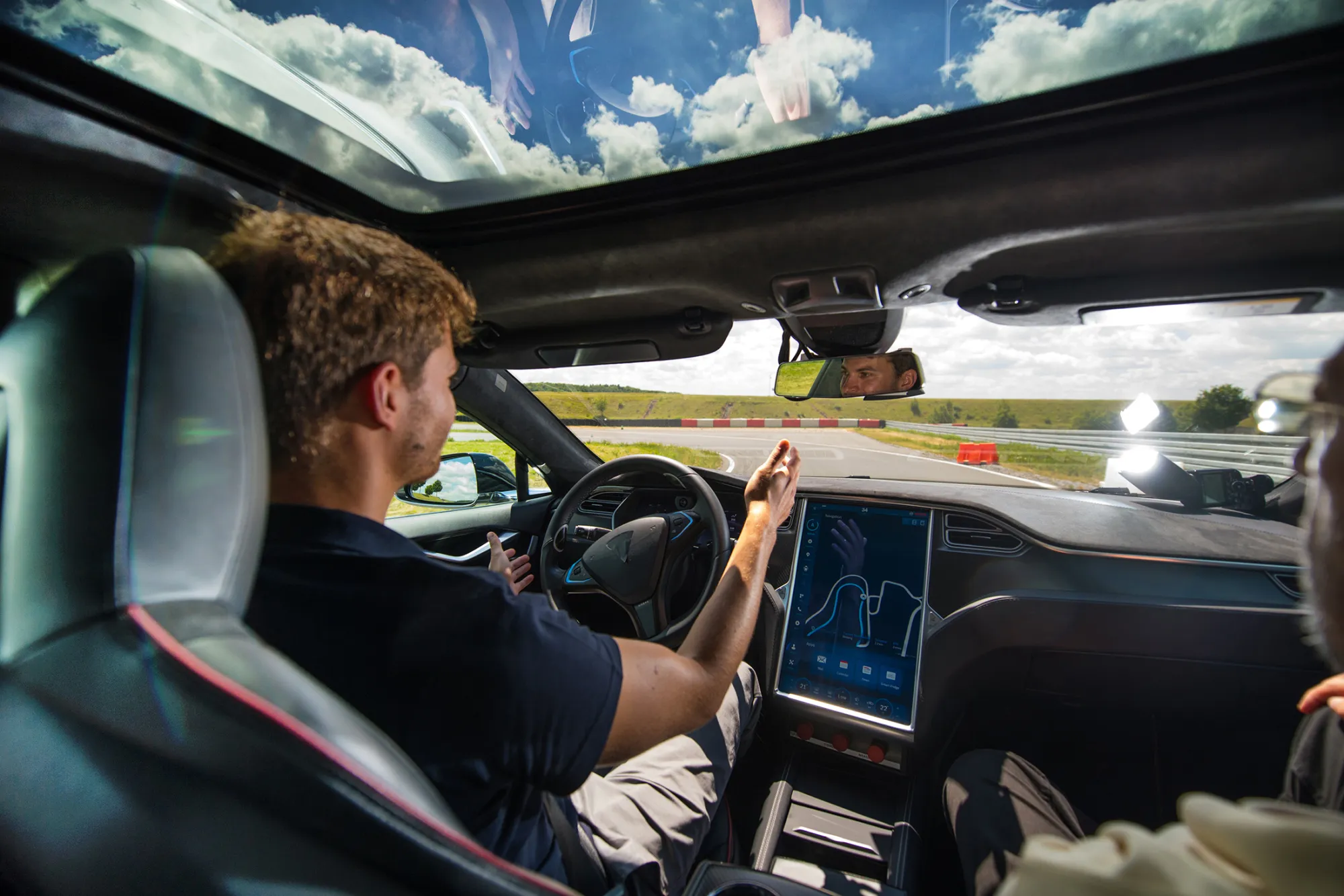 A test driver removes his hands from the steering wheel of a Tesla Model S in Boxberg, Germany, on July 4, 2017.
