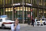 Traffic and pedestrians pass a Fidelity Investments office in Boston, Massachusetts