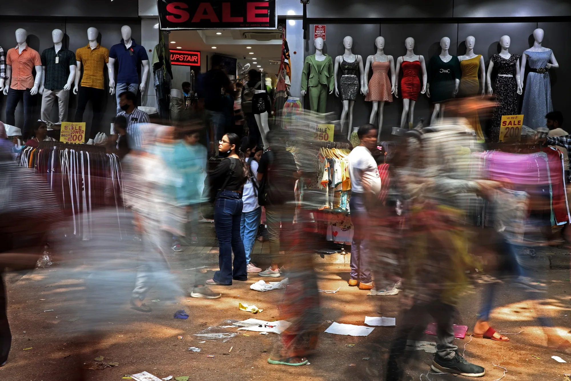 Shoppers pass&nbsp;at a marketplace in New Delhi.