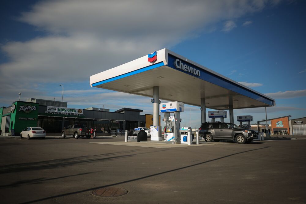 Vehicles sit parked at a Chevron Corp. gas station in Calgary, Alberta.