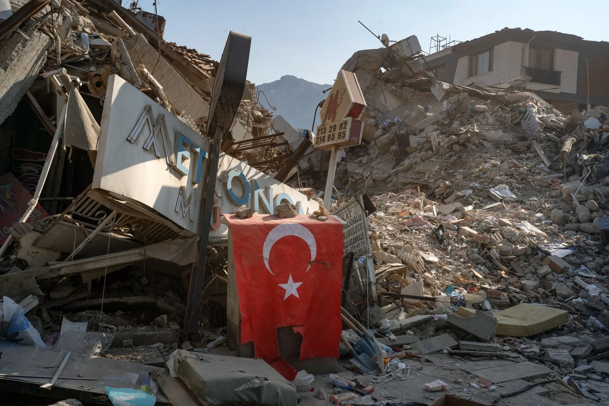 A Turkish national flag placed at the site of a collapsed building in Hatay, Turkey, on Feb. 12.