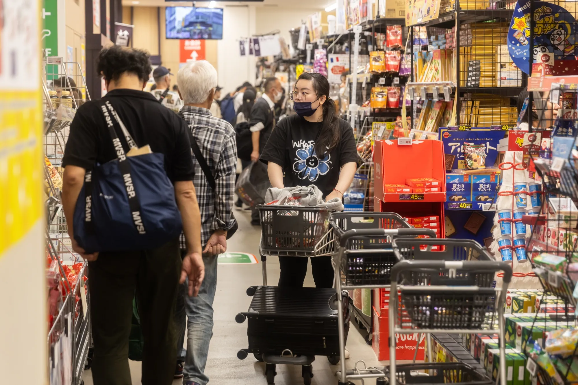 Customers shop at a supermarket in Tokyo.