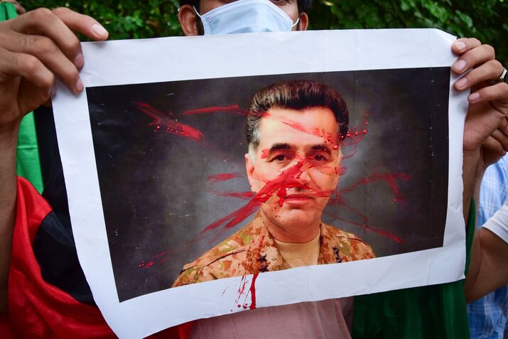 A protester holds a picture of Pakistan's Inter-Services