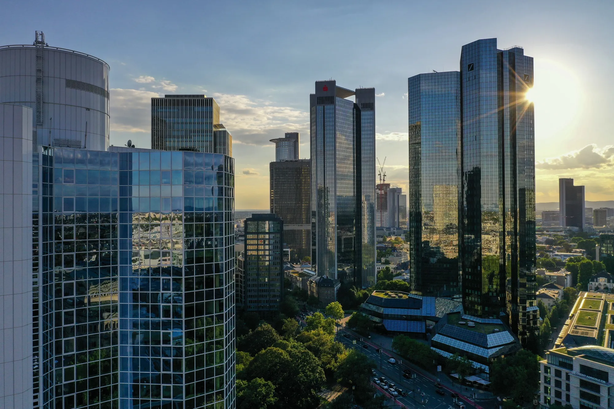 The Deutsche Bank AG twin tower headquarters, right, stand beside the Frankfurter Sparkasse Tower, center, on the financial district skyline in Frankfurt, Germany.