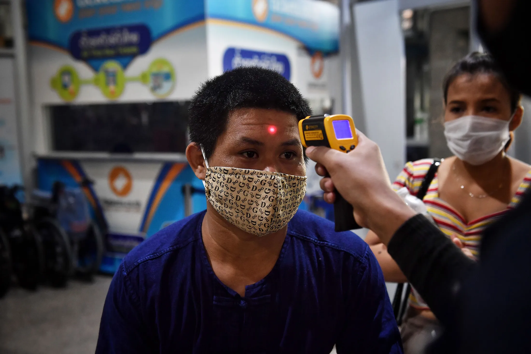 A man has his temperature checked&nbsp;in Bangkok on March 23.&nbsp;