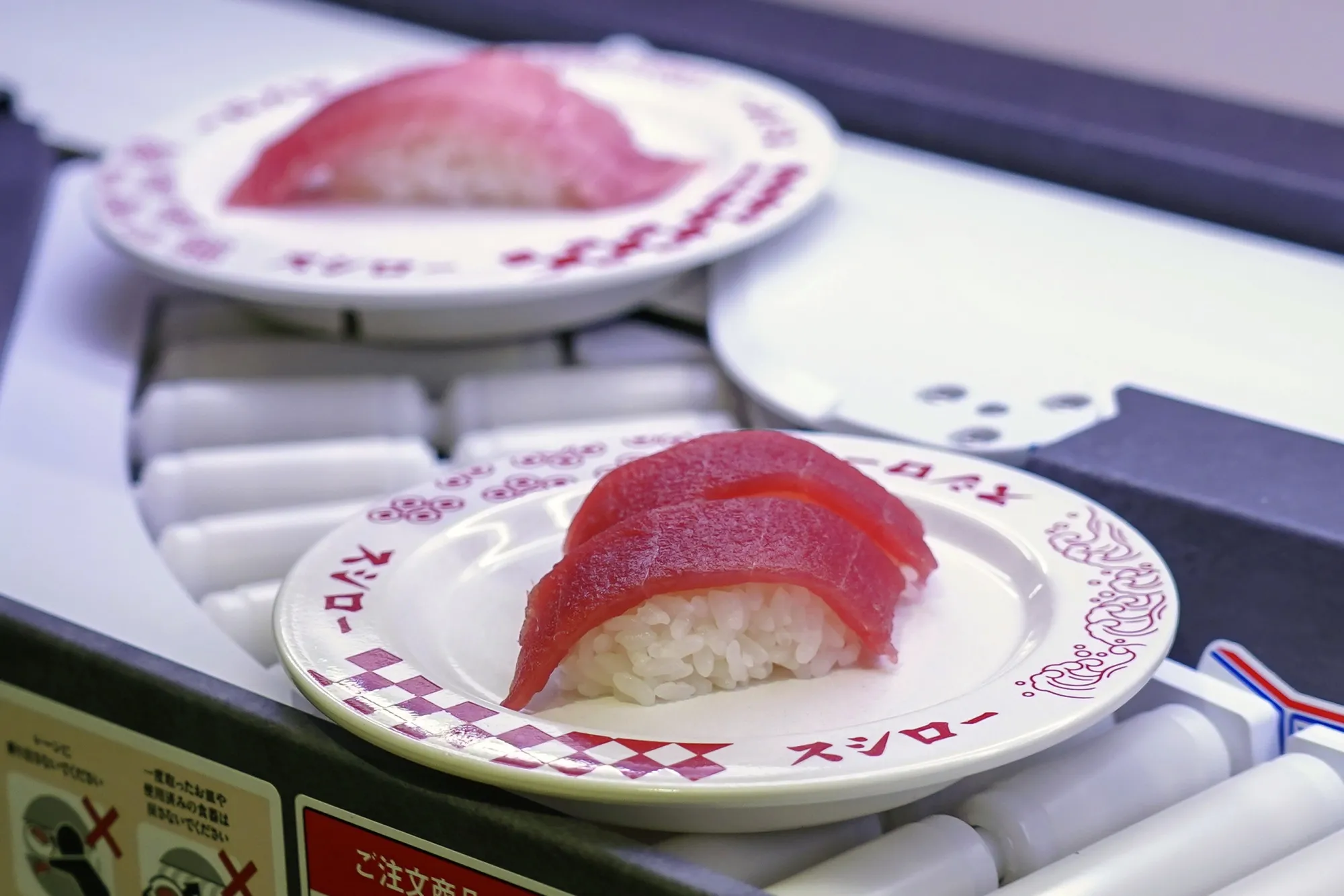 Plates of sushi move along a conveyor belt at a Sushiro restaurant in Tokyo.