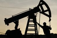 An Oil Worker Works on an Oil Pump