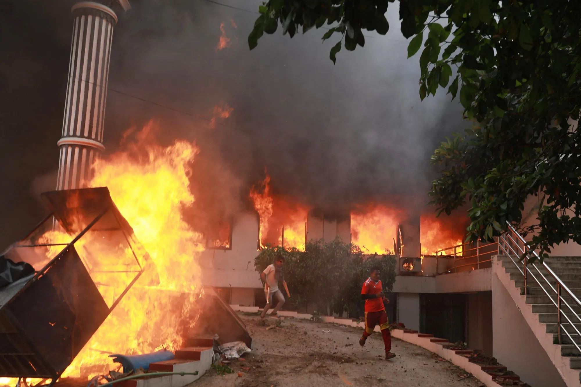 Protestors&nbsp;outside the burning Nepali Congress Party office during a demonstration&nbsp;in Kathmandu today.