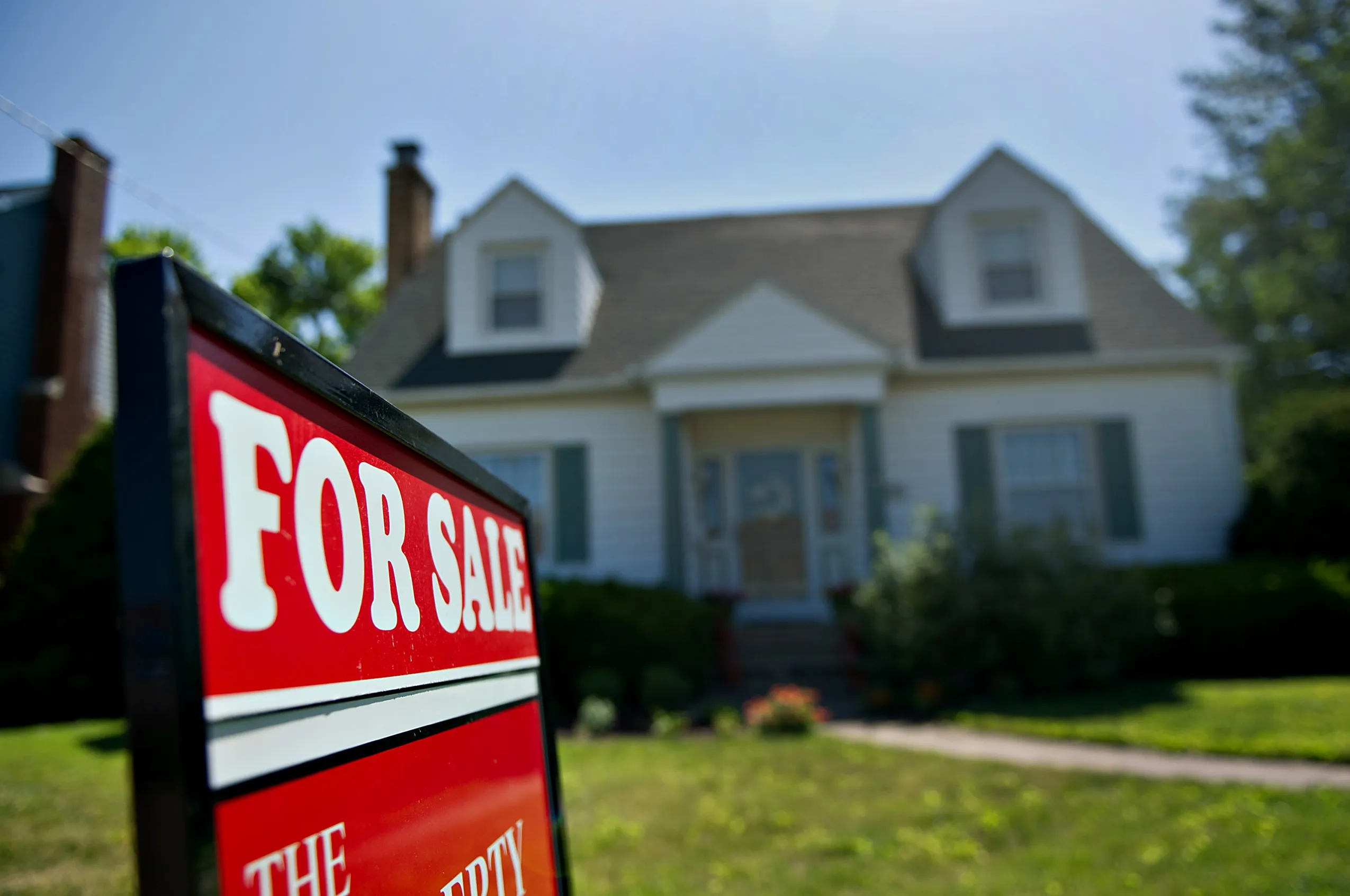 A for sale sign stands outside of a home in Princeton, Illinois.