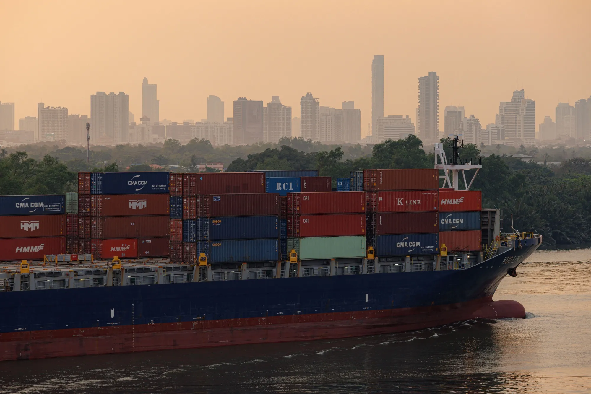 A container ship sails along the Chao Phraya river near the Bangkok Port in Bangkok.&nbsp;