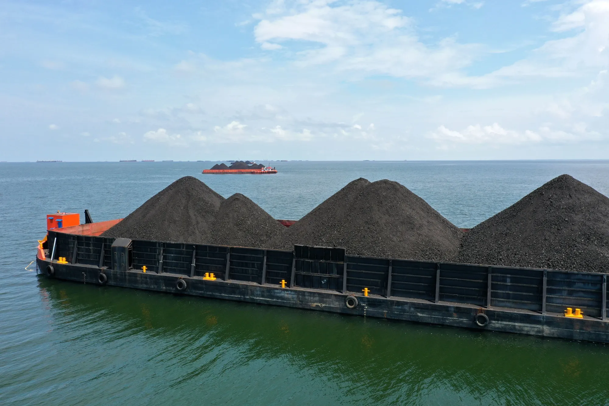 A barge loaded with coal anchored offshore in Muara Berau, Indonesia, in October 2021.