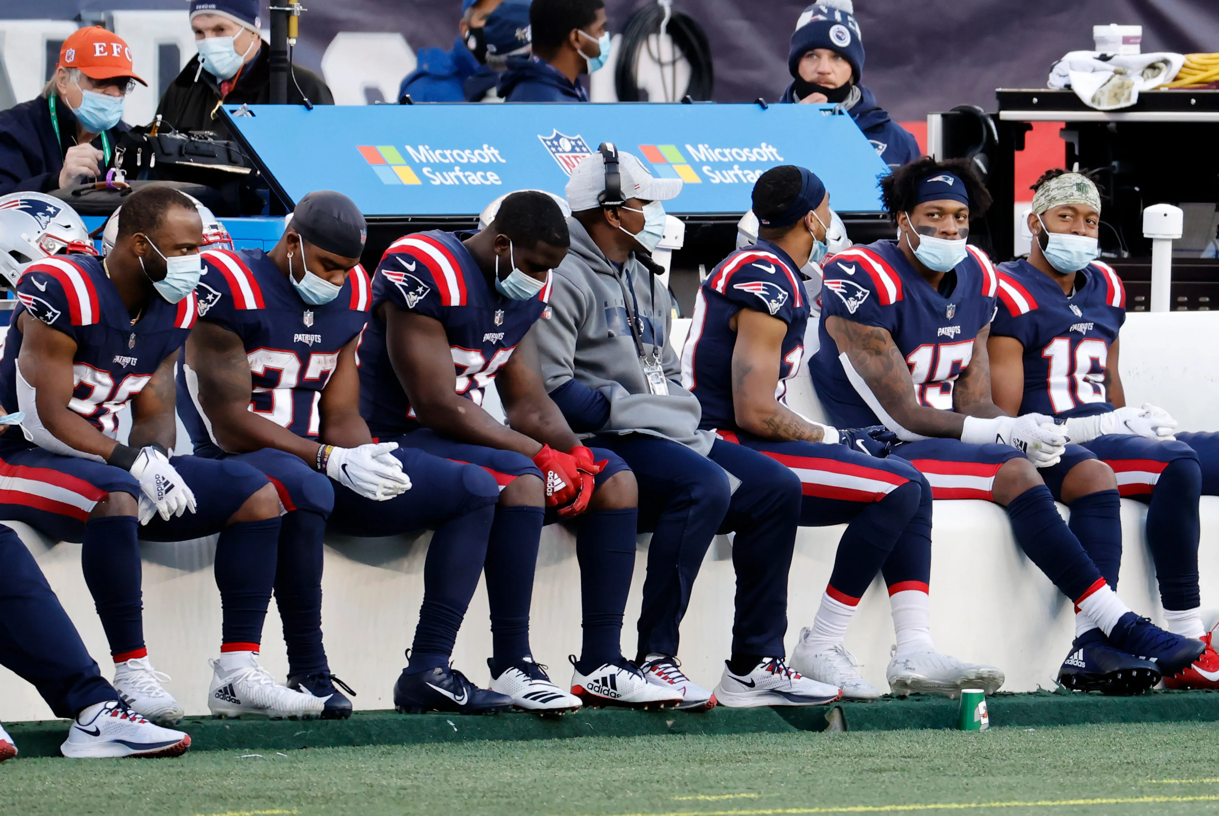 Patriots players wear masks on the bench during a game in Foxborough, Mass., on Nov. 29, 2020.&nbsp;