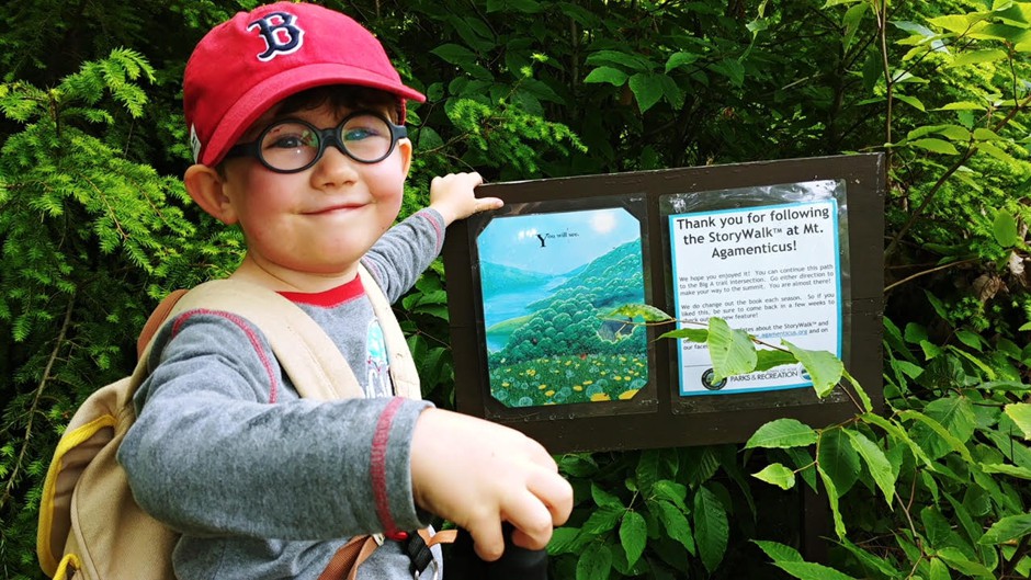 Four-year-old Will Leahey reaches the end of a StoryWalk installed along Mt. Agamenticus in Cape Neddick, Maine.