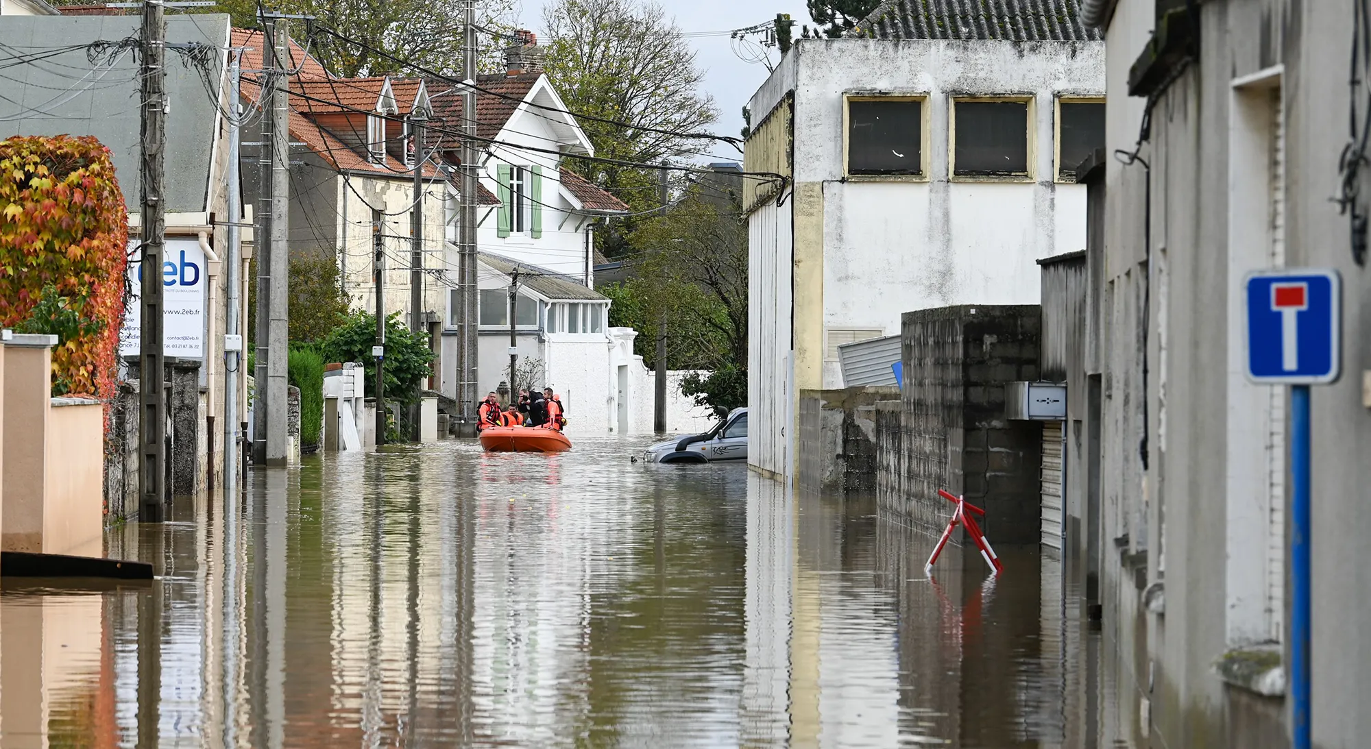 Firefighters ride down a flooded street in&nbsp;Saint-Etienne-au-Mont, near Boulogne-sur-Mer on Nov.&nbsp;5.