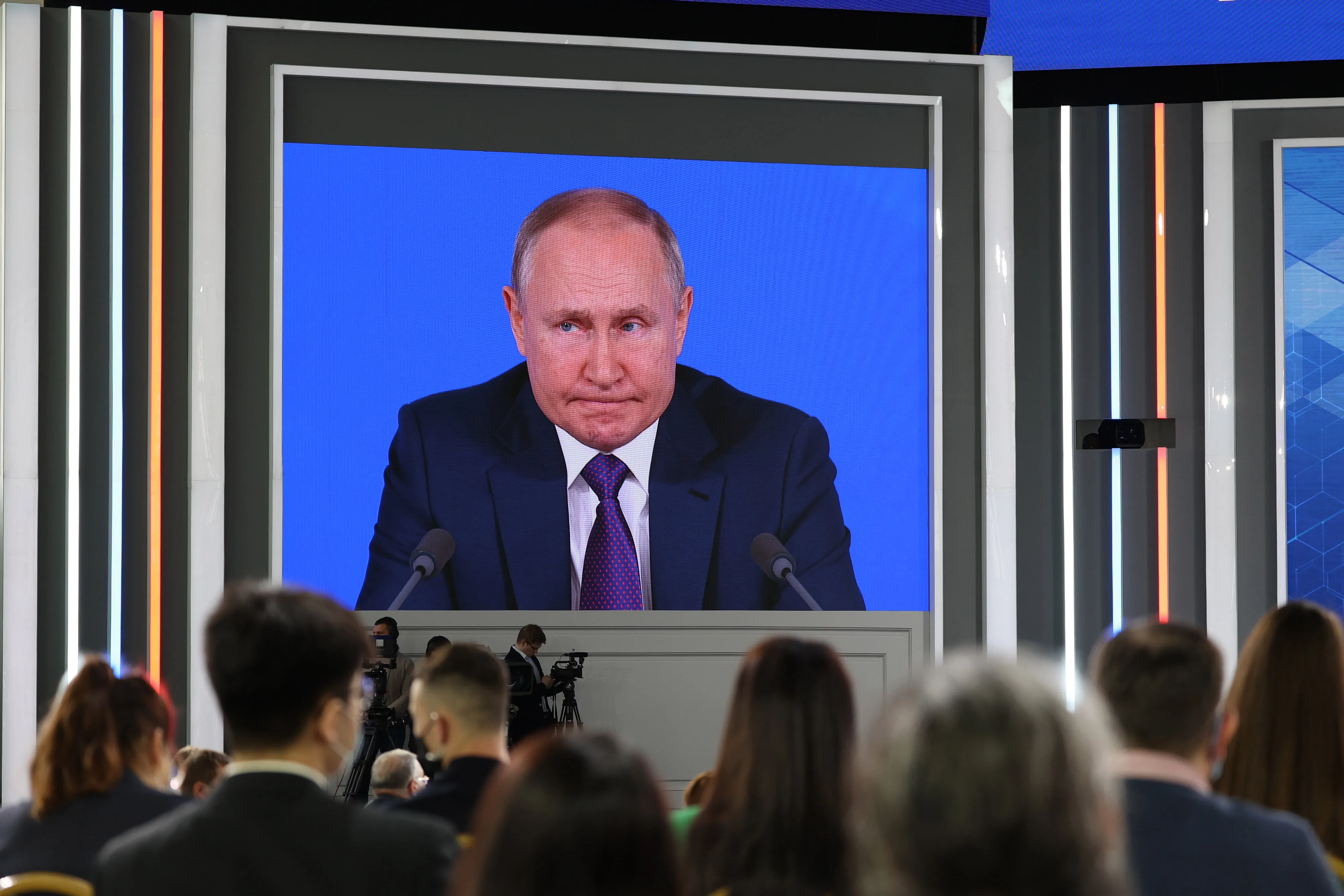 Attendees watch Vladimir Putin, Russia's President.