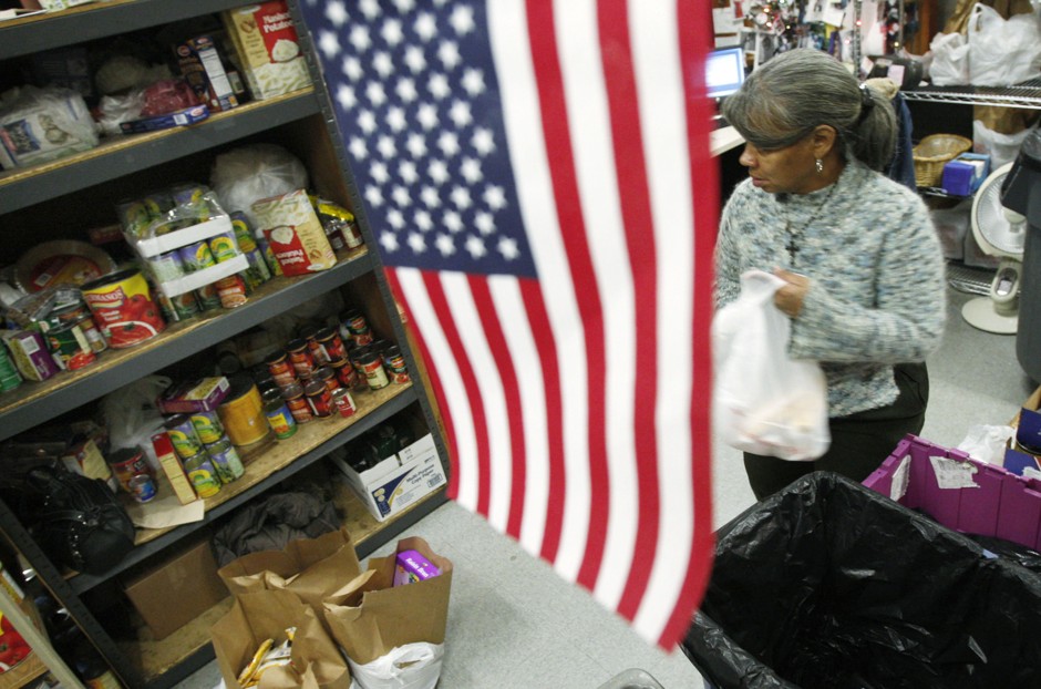 A volunteer fills a box with food at the Bread for the City food pantry in Washington, D.C.