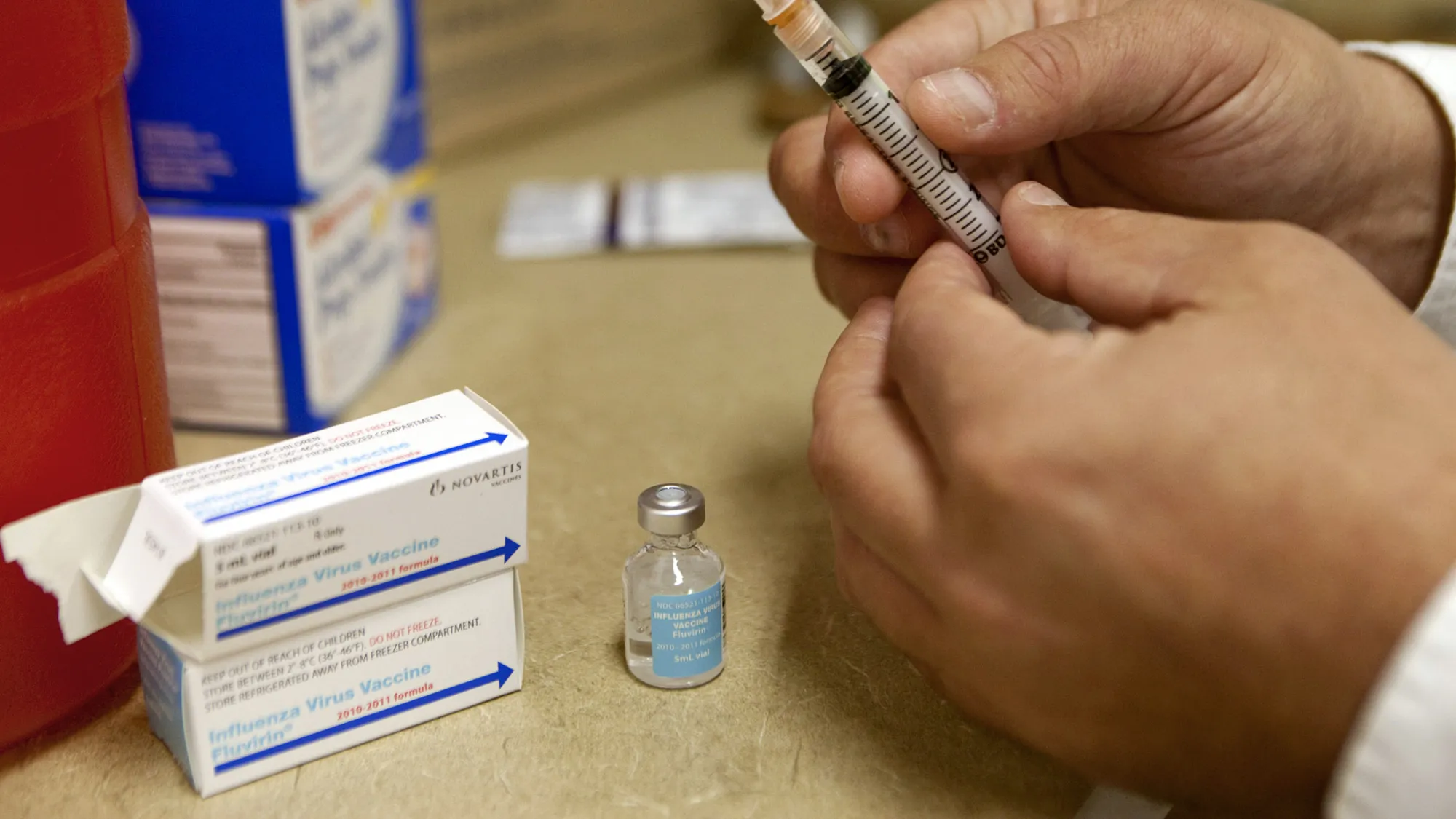 Pharmacist Michael Frazzetta prepares a Novartis flu vaccine shot for demonstration purposes at a CVS store in New York, U.S., on Tuesday, Aug. 24, 2010. CVS Caremark Corp., the largest U.S. buyer and seller of prescription drugs, will begin offering flu vaccinations at all 7,000 stores in the U.S. beginning next week.
