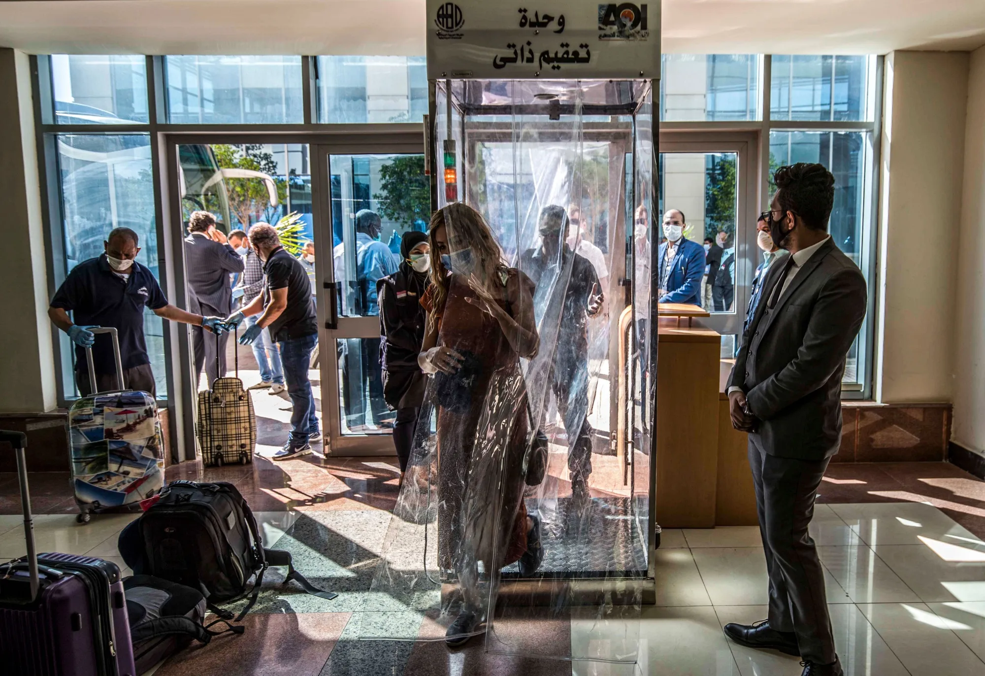 A traveller passes through an automatic disinfection booth at the entrance of the seaport in Hurghada, Egypt, on June 19.