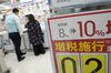 A point-of-purchase display on consumption tax increase is seen as a customer and employee look at washing machines displayed for sale at a Bic Camera Inc. electronics store in Tokyo, Japan, on Thursday, Sept. 5, 2019. Overly optimistic views of how the economy would ride out the sales tax in 2014 left red faces in government offices and the Bank of Japan when the economy shrank 7.3% in its aftermath. This time round, Prime Minister Shinzo Abe’s administration has bent over backwards to ensure that the tax hike doesn’t upend the economy at a highly vulnerable time.