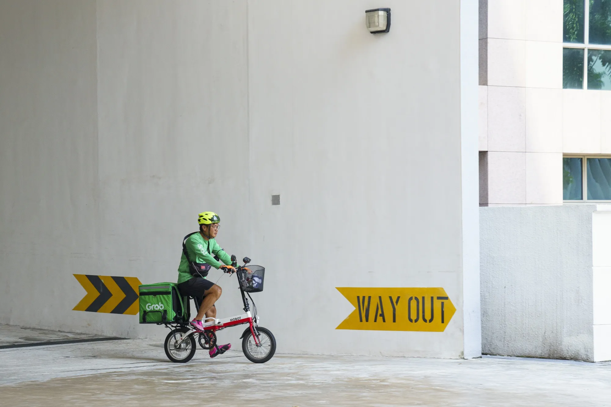 A delivery driver for GrabFood, Grab Holdings Inc.'s online food-delivery platform, delivers an order in Singapore.