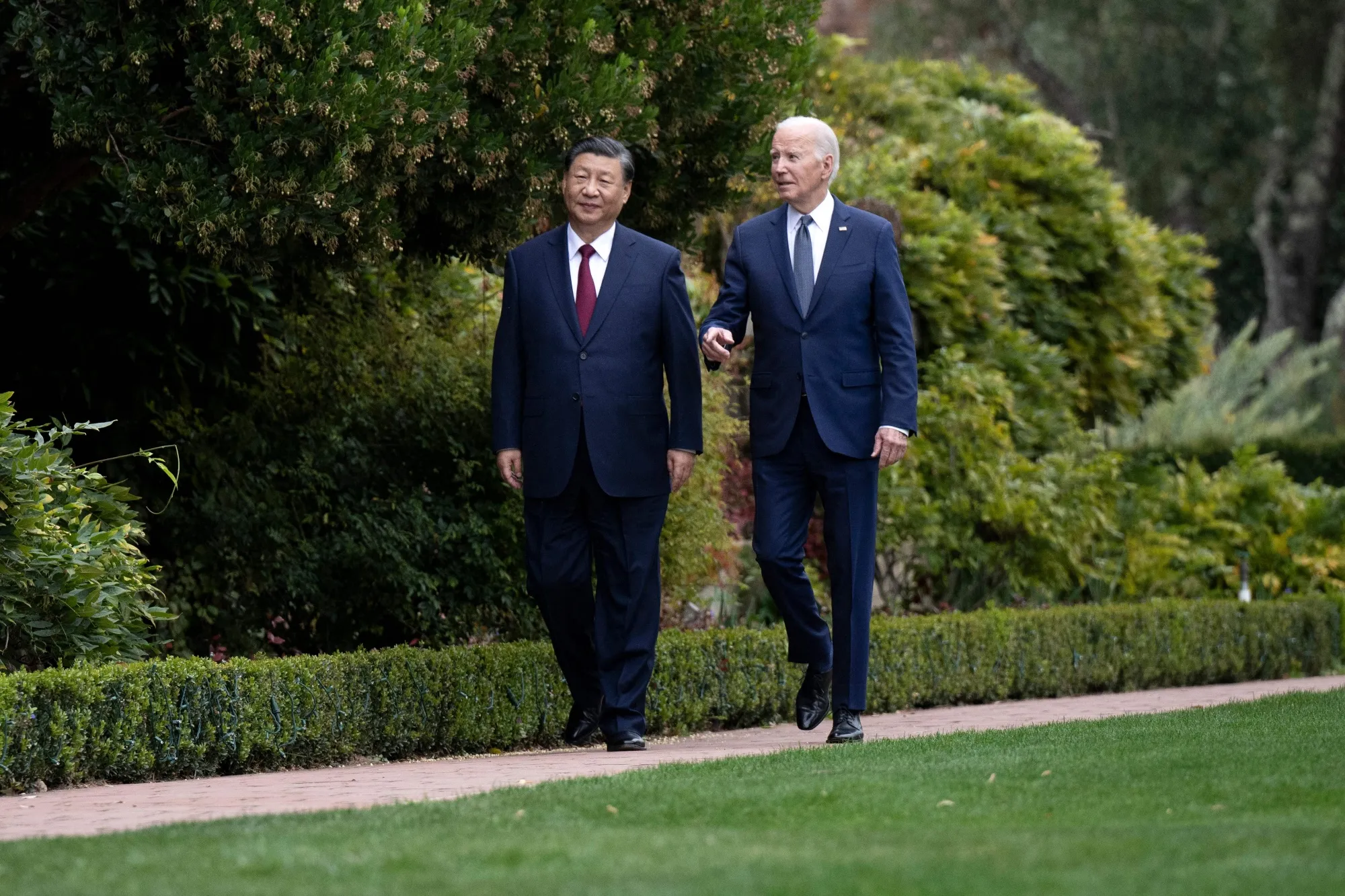 US President Joe Biden and Chinese President Xi Jinping walk together after a meeting in Woodside, California, on Nov. 15.