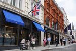 Shoppers pass luxury stores on New Bond Street in London.