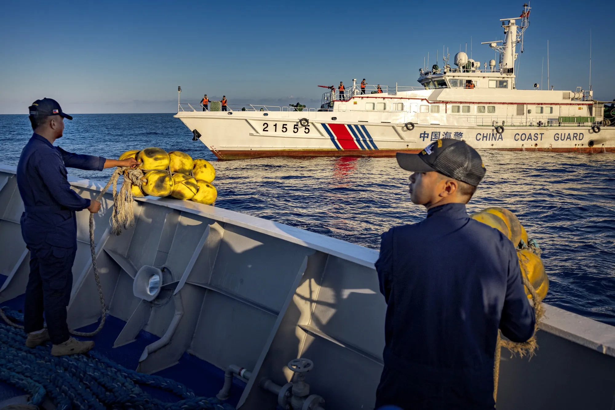 Philippine Coast Guard personnel of BRP Sindangan deploy fenders as they brace for a collision with a Chinese Coast Guard ship on March 5.