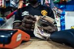 A cashier counts out Nigerian naira banknotes in a store in Abuja.