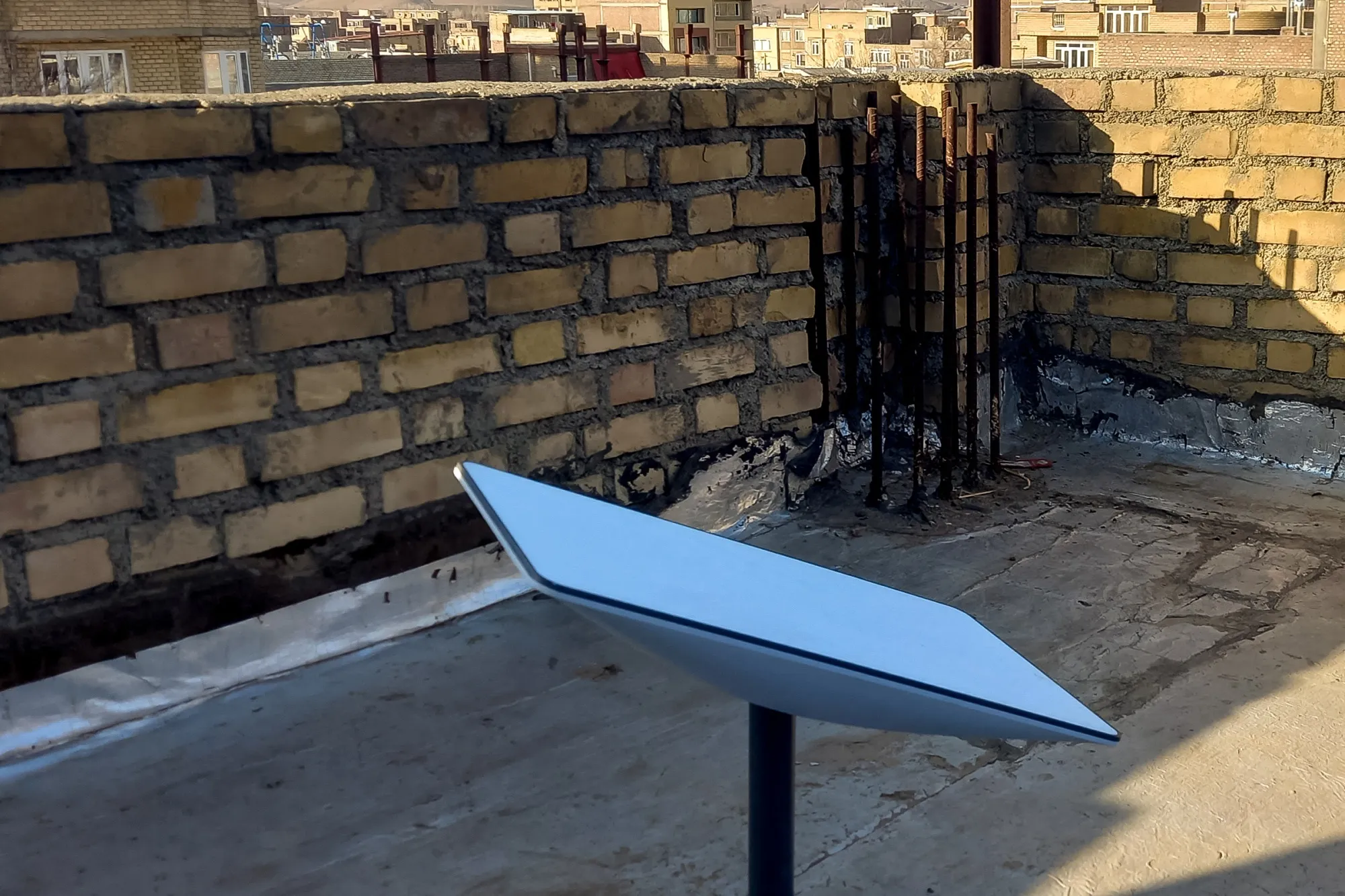A Starlink receiver sits atop a house in Kurdistan, Iran.