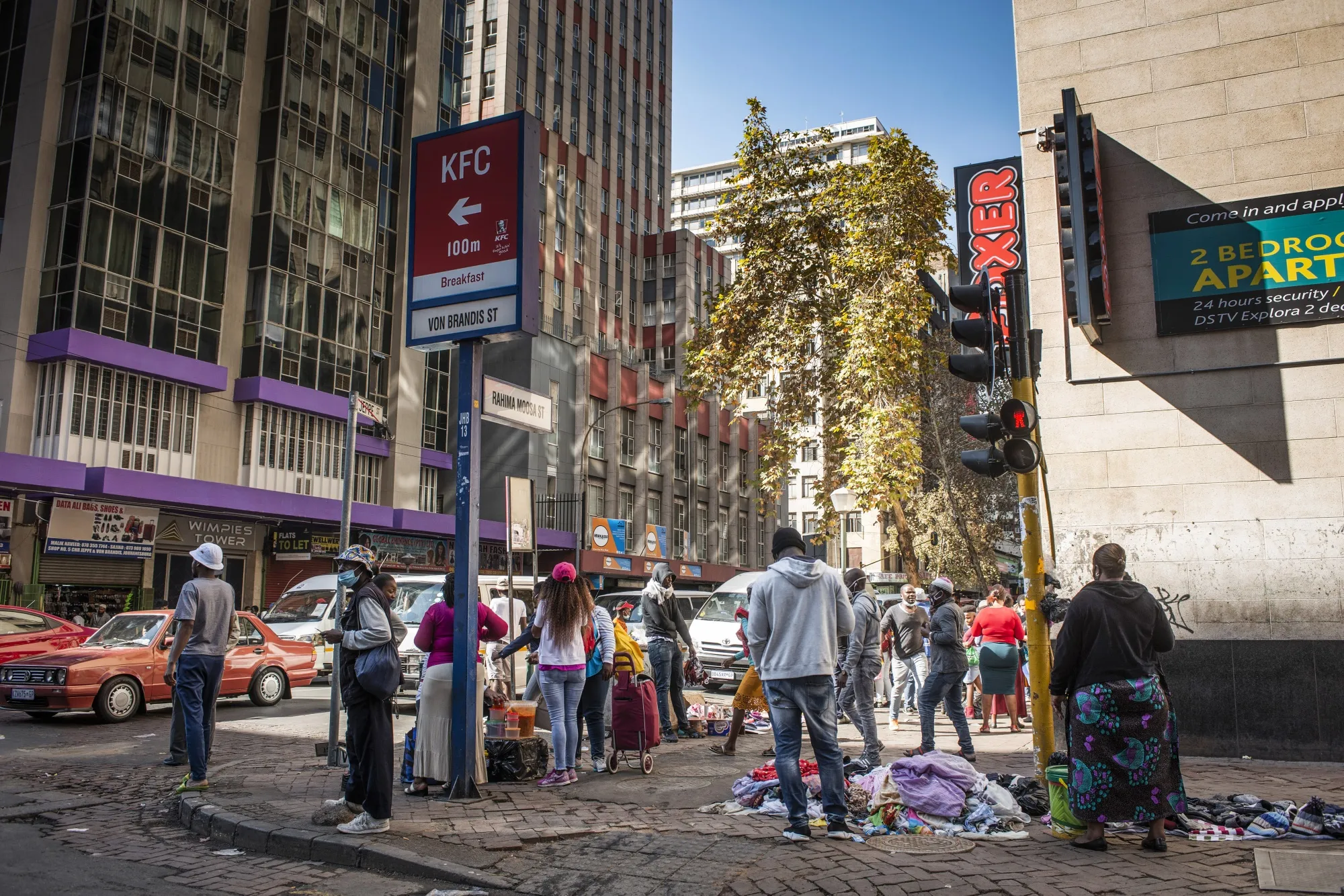 People gather on a street corner in the Central Business District&nbsp;of Johannesburg, on May 7.