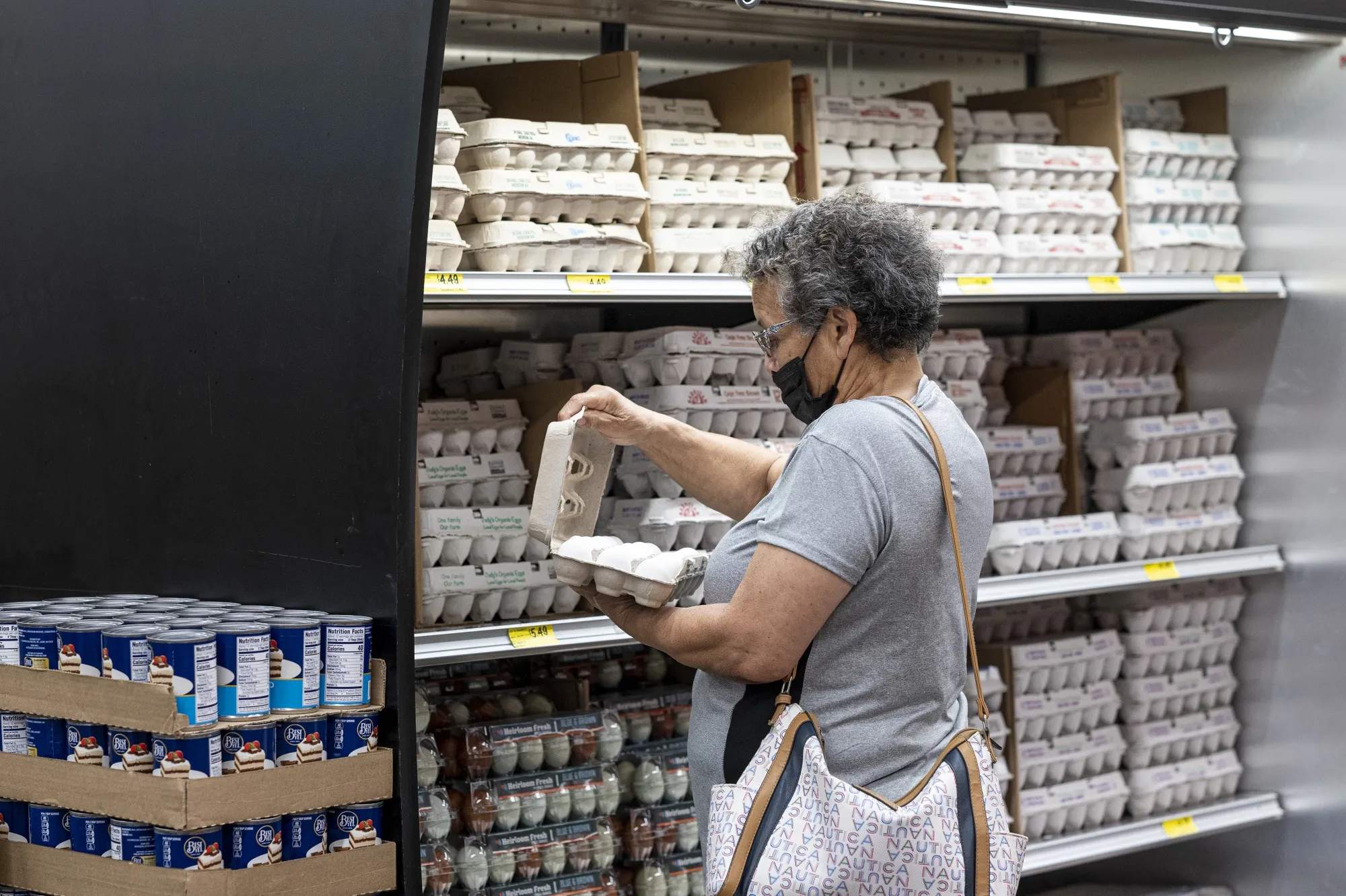 A shopper checks a carton of eggs at a grocery store in San Francisco,&nbsp;on&nbsp;May 2.