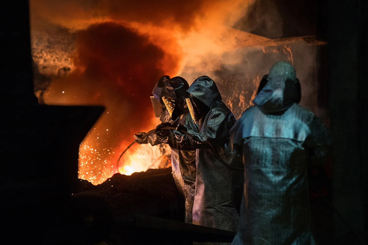 Workers at the blast furnace during the iron smelting process in Duisburg, Germany.