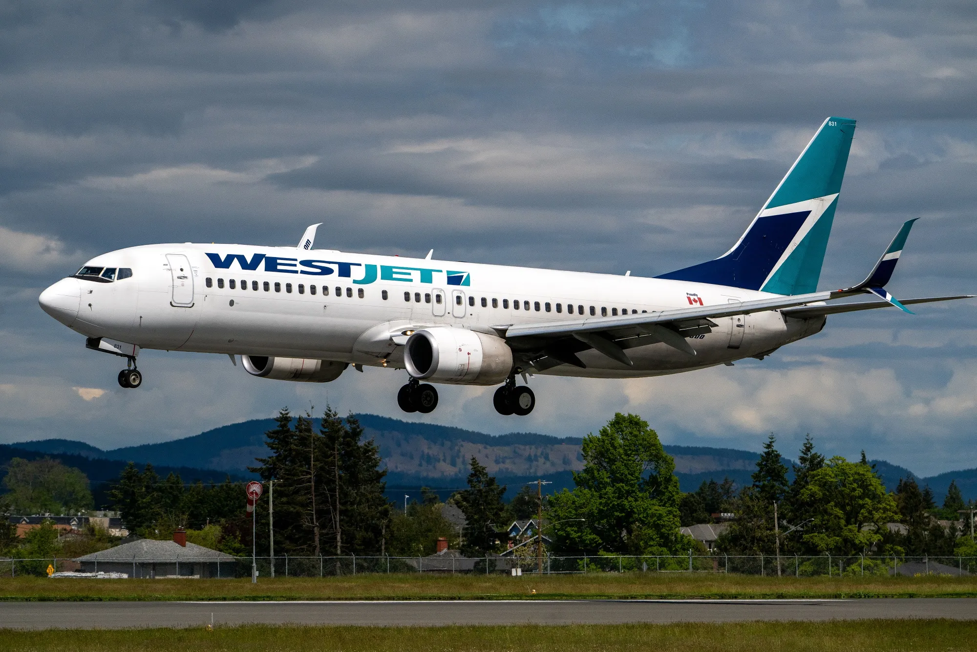 A WestJet airplane lands at Victoria International Airport in Victoria, British Columbia, Canada.