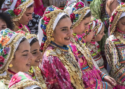 Girls wearing gold coin necklaces on Assumption Day in Olympos.